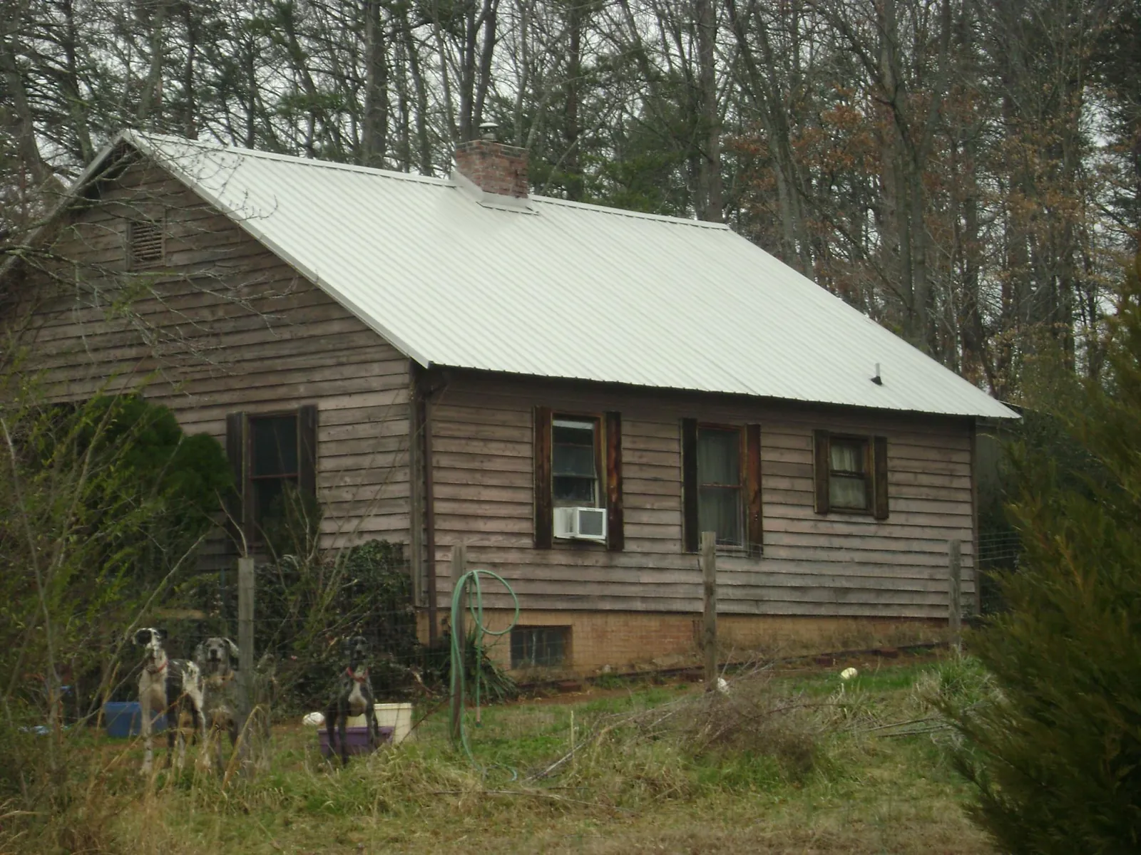 White metal roof on an old wood sided farmhouse, from a Asphalt Shingle Roof Repair job in Rumford