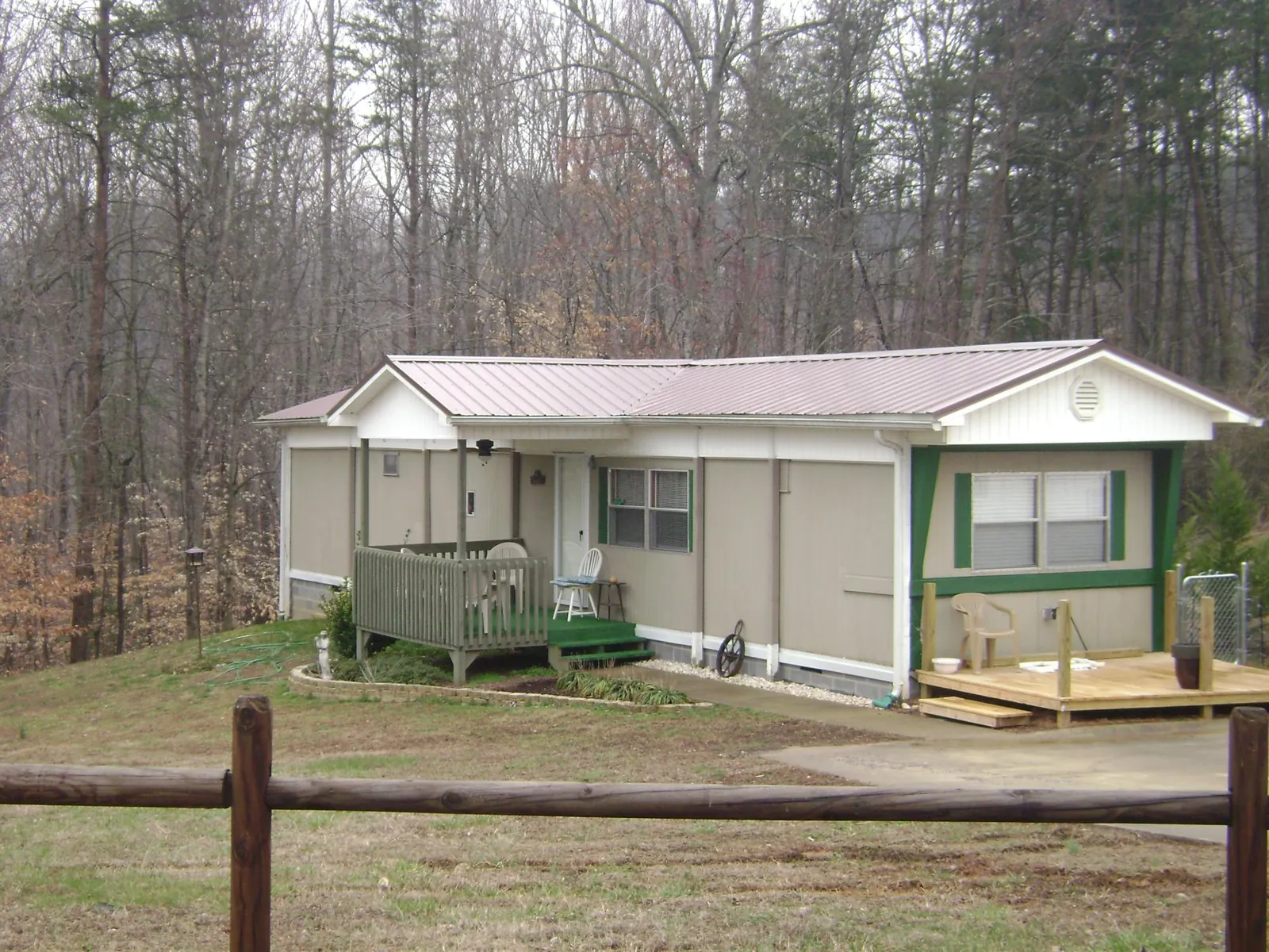 Mauve metal roof on a manufactured home with a new front deck in Rumford